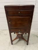 A Georgian mahogany fold over top wash stand cupboard, standing on square section legs with the