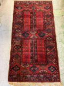 A wool runner, red grounds with geometric border 107cm x 85cm