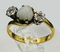 An opal and diamond ring. centre heart shaped opal with diamond shoulders on an 18ct yellow gold