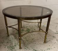 A circular Mid Century brass and smoked glass coffee table (H41cm Dia62cm)