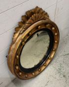 An 19th Century giltwood and Gesso convex wall mirror with a fan pendant (H68cm Dia58cm)