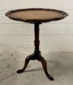 A mahogany pedestal tilt top table on splayed legs