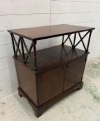 A mahogany two door music cabinet with shelf over (H76cm W70cm D40cm)