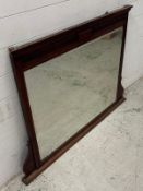 An Edwardian bevel edge over mantel mirror with foxing to edge 123cm x 88cm