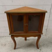 A small pine two door glazed corer cabinet (H62cm W49cm D27cm)