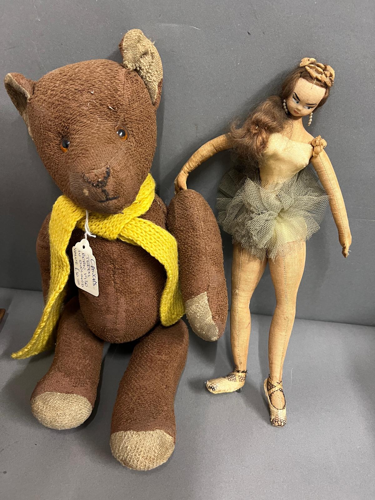 A teddy bear with jointed legs and arms along with a ballerina doll