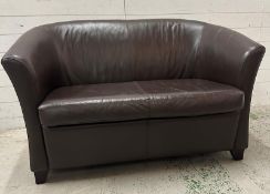 A brown two seater faux leather sofa