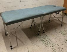 A blue collapsible massage table