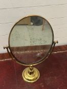 An oval swivel mirror (H58cm)