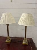 A pair of onyx and brass table lamps