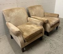 A pair of fawn upholstered arm chairs