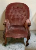 A Victorian button backed arm chair on castors upholstered in pink
