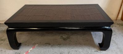 An Oriental Chow leg coffee table with rattan top (150 x 92 x 153)