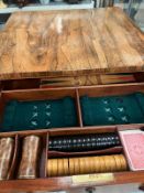A rosewood games table with drawers, opening to reveal chess and backgammon boards, on turned