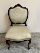 An upholstered French style side chair on scrolling frame
