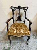 An Edwardian mahogany arm chair with carved back on cabriole legs, upholstered in ivory grounds