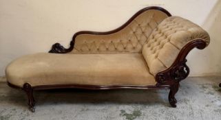 A mahogany button backed chaise longue upholstered in a beige fabric