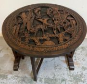 A Chinese carved tilt top tea table (H51cm Dia61cm)