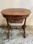 A walnut sewing table with inlaid top and opening to compartments
