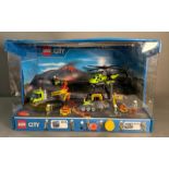 A Lego shop display featuring a helicopter, boring machine and other excavating machines with
