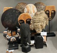 A selection of tribal mask sculptures and decorative items