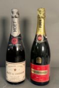 A bottle of Moet and Chandon Premiere Cru and a bottle of Piper Heidsieck champagne