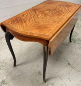 An inlaid French style side table with drop sides, cabriole legs with gilt metal mounts