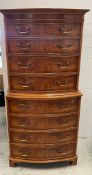 A serpentine burr walnut style chest on chest (H157cm W76cm D40cm)