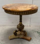 A circular onyx and brass side table on triform base (H57cm Dia49cm)
