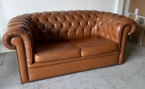 A Chesterfield two seater sofa, upholstered in leather (H68cm W1647cm D90cm)