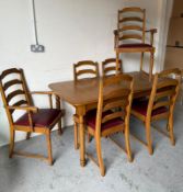 A light oak style table with six ladder back chairs (one chair AF)