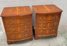 A pair of serpentine bedside cabinets on bracket feet (H64cm W52cm D40cm)