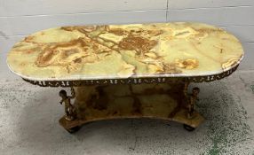 A green onyx two tier coffee table with figural supports (H46cm W114cm D49cm)