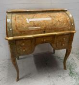A French marquetry cylinder top desk with gilt ormolu mounts, the fall opening to four drawers and a