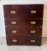 A campaign style secretaire, with fall-front opening to reveal fitted interior and drawers below,