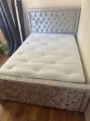 A crushed velvet upholstered double bed with mattress.