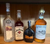 Four bottles of spirits, a Jim Beam, a Southern Comfort, A Kirsch and a Cachaca Triunfo