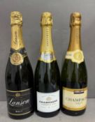 Three bottles of champagne. A Lanson, a Kirkland and a premier cru.