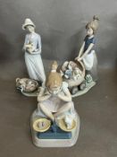 A selection of three Lladro figures, young lady with kitten on scales, young lady with pram of dogs,