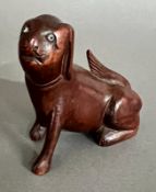 A 19th century carved treen wood figure of a mythical dog. Height 7cm approximately