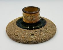 A Lambeth Doulton 'Dewars' match striker, mark to base and approximately 15cm in diameter.