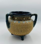 A Lambeth Doulton stoneware jardinere decorated by Ethel Beard, standing on three feet with three