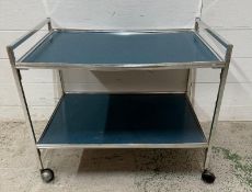 A Mid Century two-tier trolley with blue Formica shelves (H53cm W64cm D41cm)