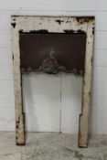 A reclaimed cast iron fireplace surround with Art Nouveau style central shield (56cm x 98cm)