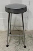 A grey vinyl padded bar stool