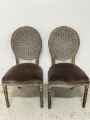 A pair of OKA Washakie dining chairs with truffle velvet upholstery