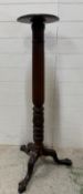 A mahogany tripod Torchere on a central fluted column and claw and ball feet (H120cm Dia29cm)
