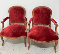 A pair of Louis XV-style armchairs with red velvet upholstery AF Condition Report One has a spilt