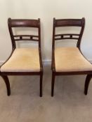 Two Regency mahogany dining chairs on sabre legs Circa 1820