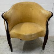 A mahogany-framed tub chair with yellow velvet upholstery